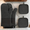A set of four heat resistant silicone oven gloves and pot pads in black with a diamond pattern displayed on a kitchen counter