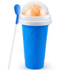 A blue Frozen Magic cup with a clear dome lid and a white straw, containing an orange frozen treat.