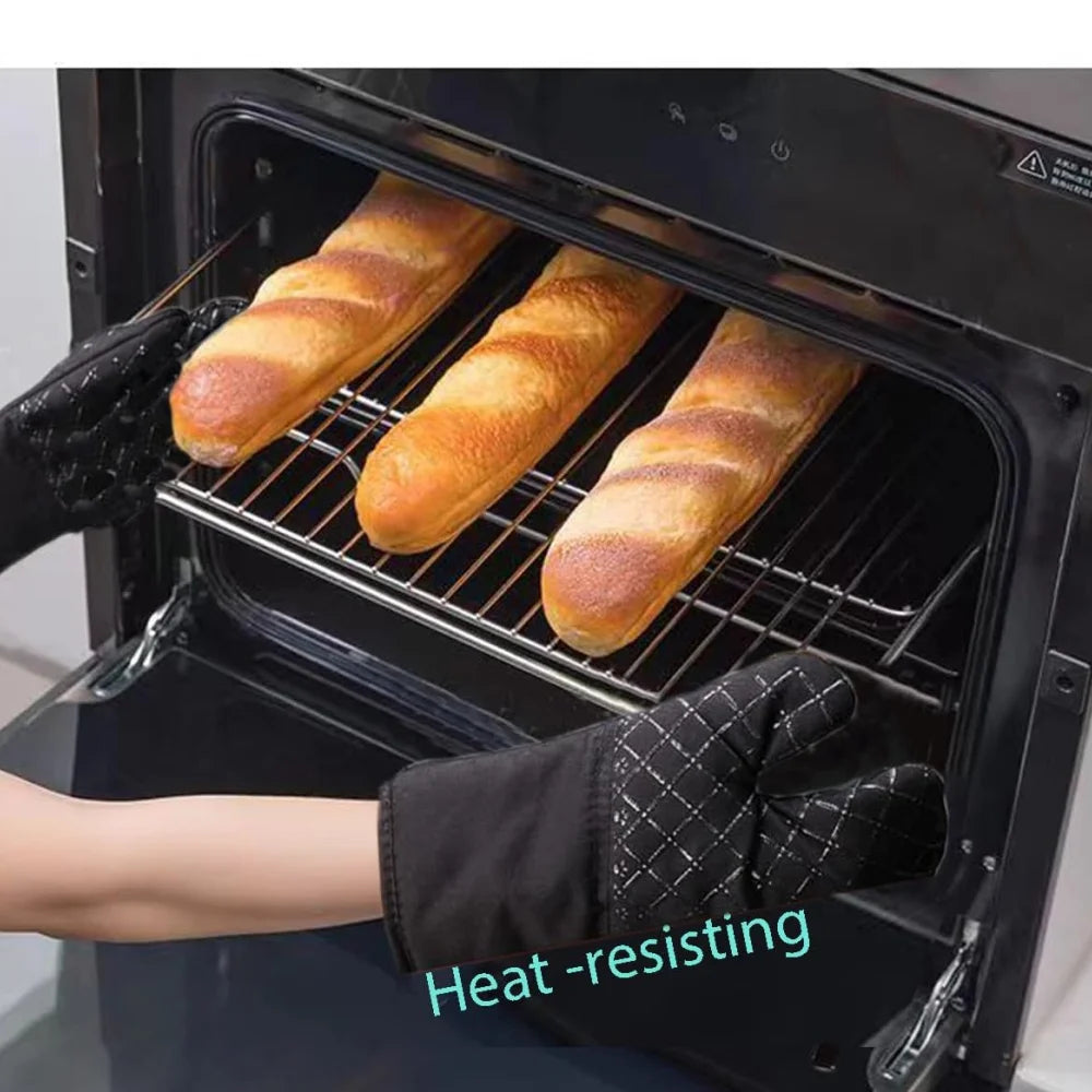A hand wearing a heat-resistant glove is placing four golden bread loaves onto a wire rack inside an oven.