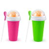 A pink and green DIY slushy maker cup with a lid and stirring stick, showing two colors.
