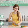A woman is using a 5-in-1 rotary vegetable cutter to slice fruit and vegetables on a cutting board.