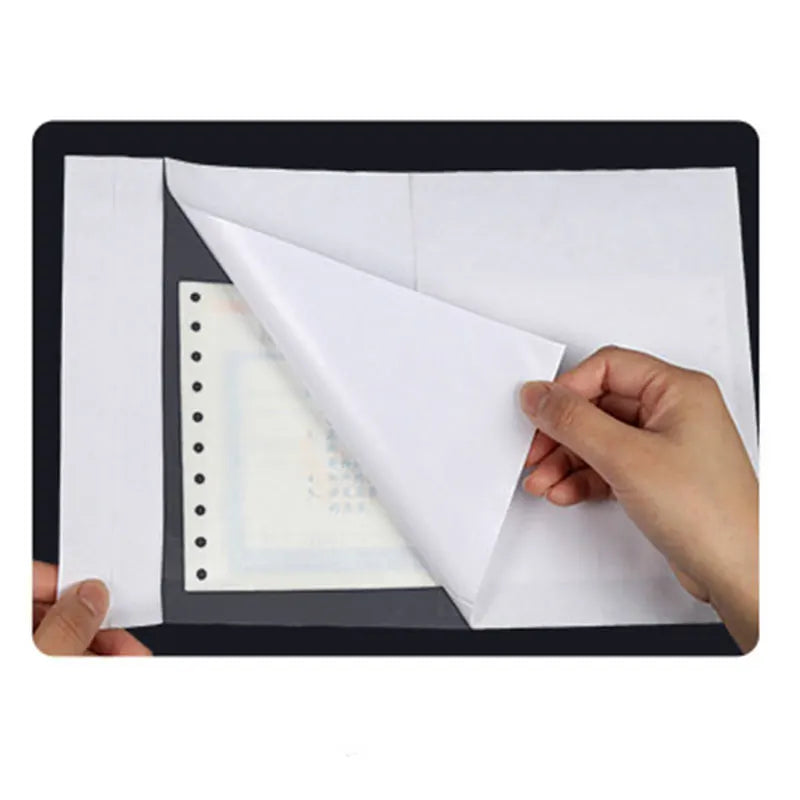 A hand is holding a white paper sheet, demonstrating clear self-seal poly mailer envelopes.