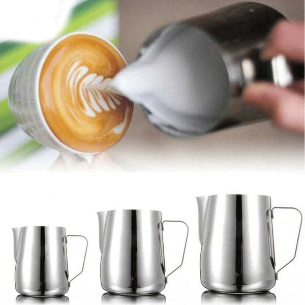 A set of three stainless steel milk pitchers shown in a close-up view.