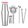 A set of professional stainless steel cocktail shakers including a shaker, strainer, muddler, and peelers.