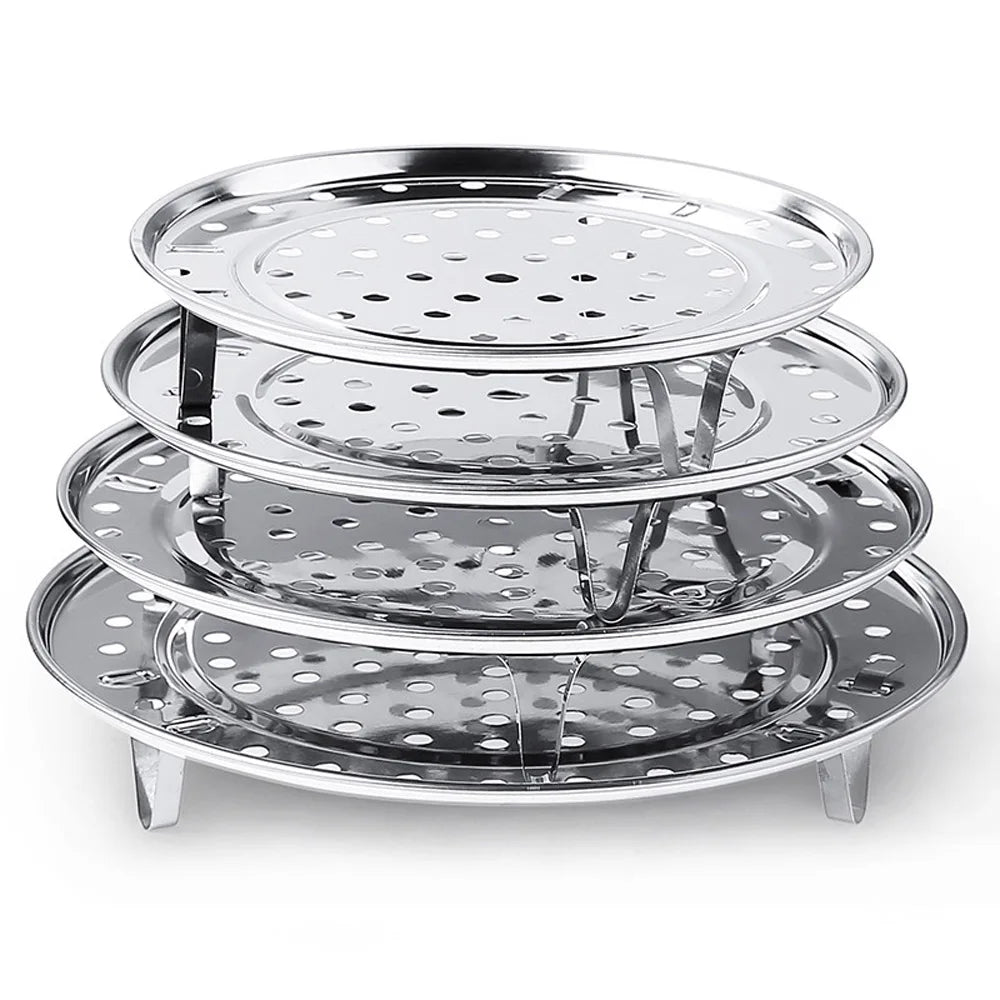 A stack of multi-size stainless steel food steamer racks with various perforated trays.