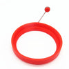 A bright red silicone ring with a metal pin, used for making egg pancakes.