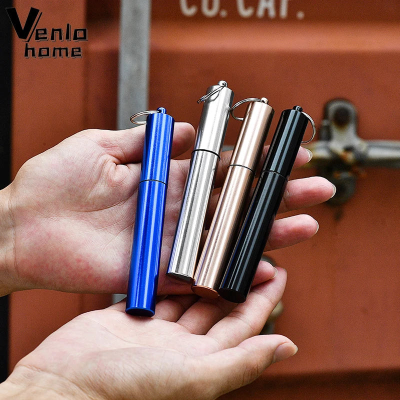 A hand holds four stainless steel telescopic drinking straws with cleaning brushes in various colors.