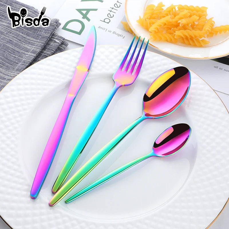 A set of elegant stainless steel flatware including a knife, fork, and spoon displayed on a white plate.