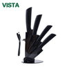 A black ceramic multi-use kitchen knife set with multiple blades displayed on a stand.