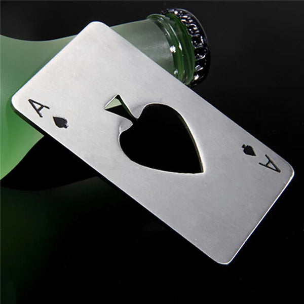 Silver poker shaped bottle opener resting on a green glass bottle.