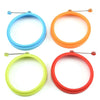 A set of silicone egg pancake rings in blue, orange, and lime green.