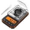 A silver digital kitchen scale with a clear lid and orange accents is shown on a white background.