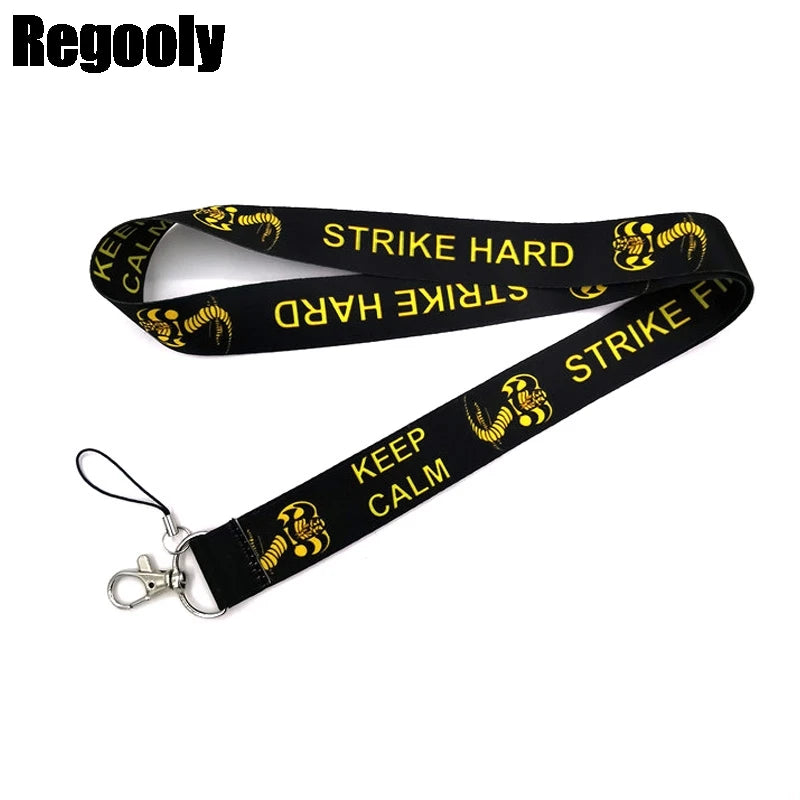 Black lanyard with yellow print featuring a snake design for ID and card holder