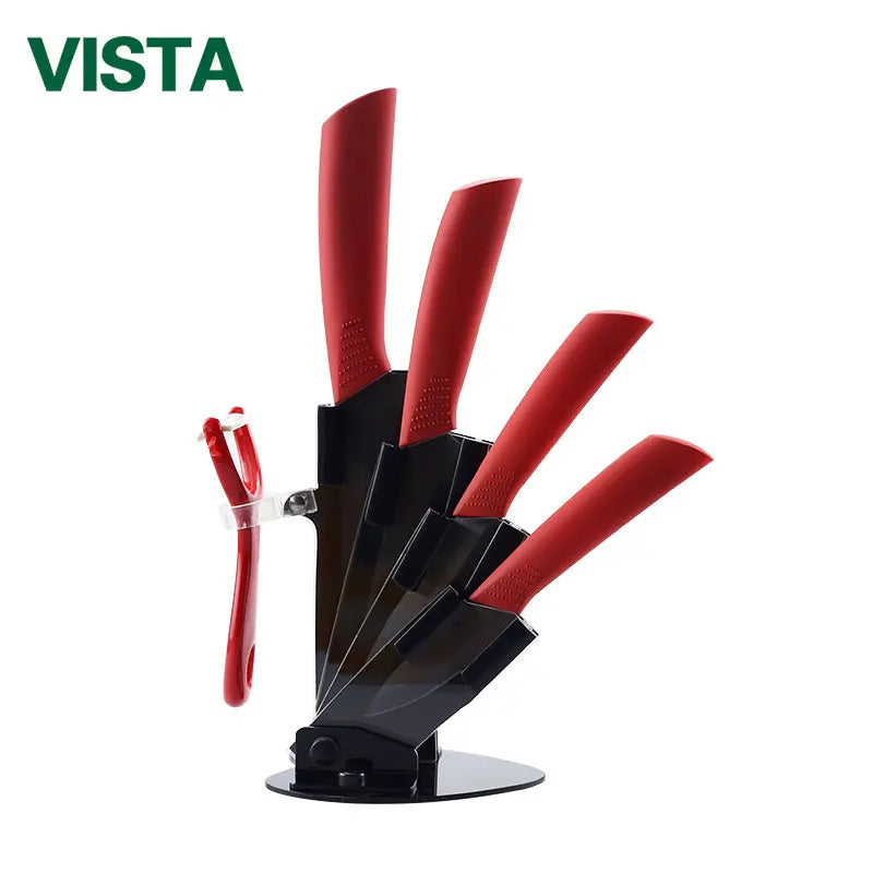 A set of red ceramic multi-use kitchen knives displayed on a black stand.