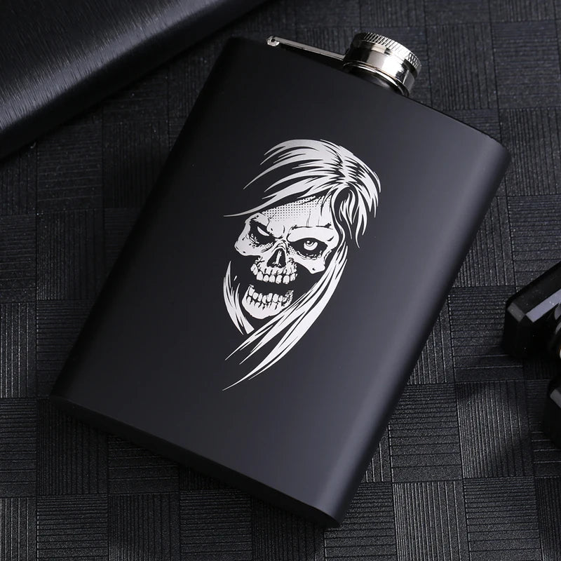 A black laser engraved stainless steel hip flask featuring a white skull design.