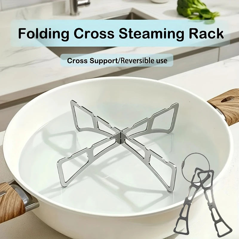 A folding cross steaming rack made of stainless steel is shown inside a white pot.