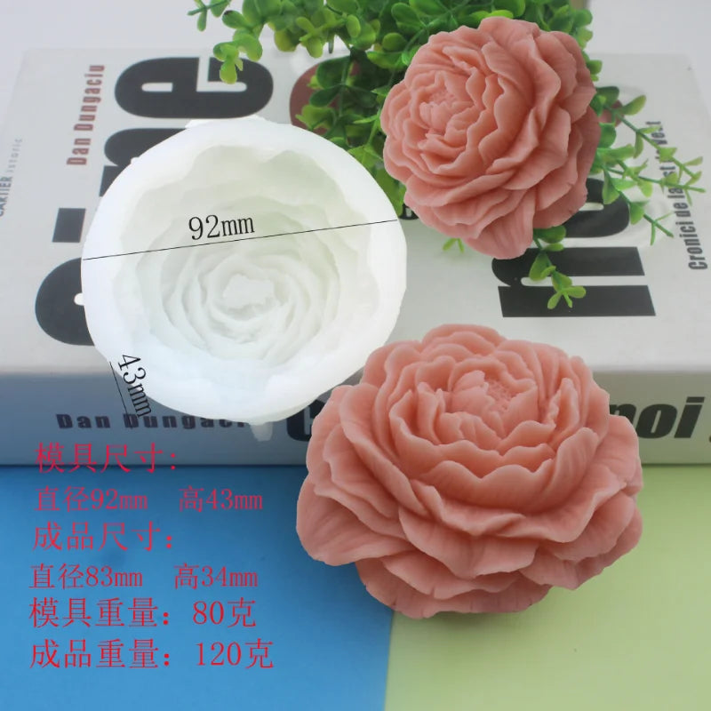 Pink silicone flower candle mold with a spiral design shown next to a finished pink rose flower.