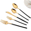 A set of gold-colored stainless steel cutlery including a spoon, fork, and knife, displayed on a white background.