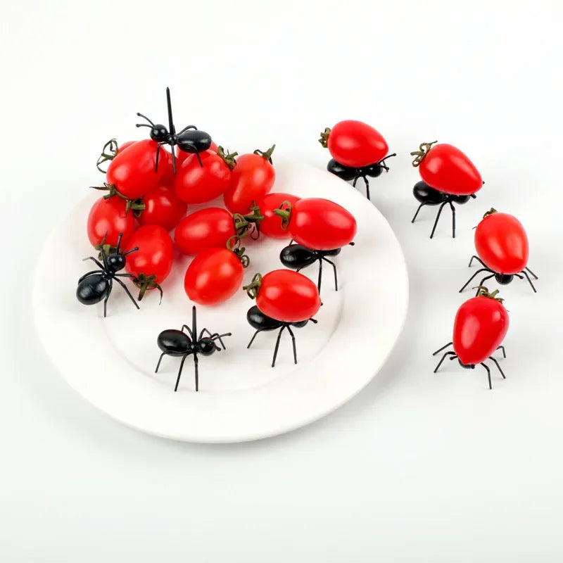 A set of reusable animal appetizer forks featuring small red and black insects on a white plate.