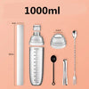 A set of premium plastic cocktail shakers, including a shaker bottle and a long spoon, displayed against a light pink backgro