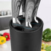 A black utensil storage holder displaying several stainless steel kitchen utensils inside.