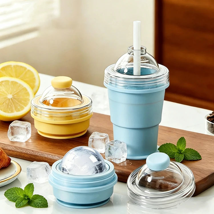 A set of reusable silicone ice ball cups and a straw in light blue and yellow colors on a wooden board.