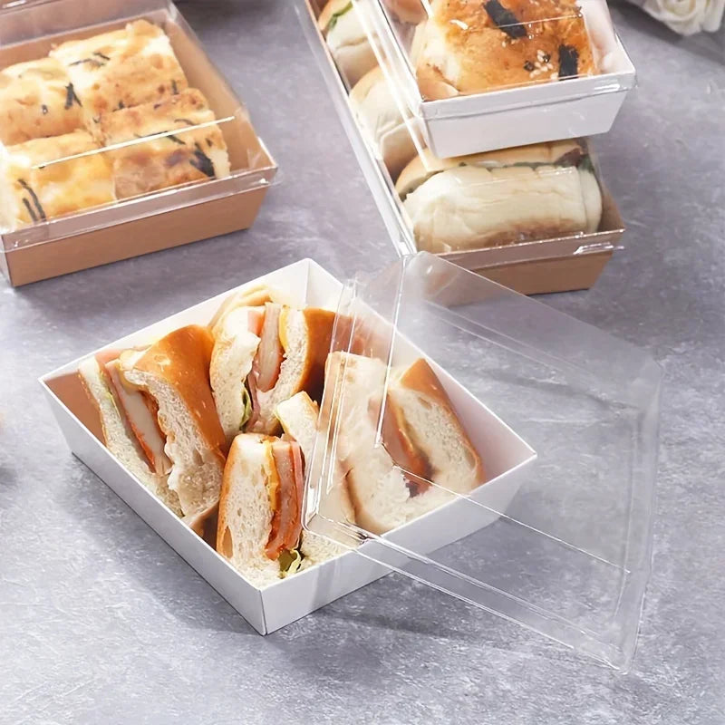 Clear plastic box containing sliced bread and sandwiches on a gray surface.