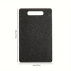 A rectangular black cutting board with a marble texture and a handle, shown from above.