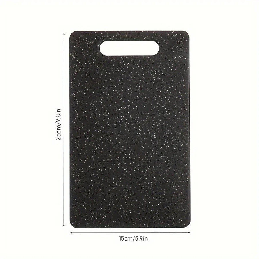 A rectangular black cutting board with a marble texture and a handle, shown from above.