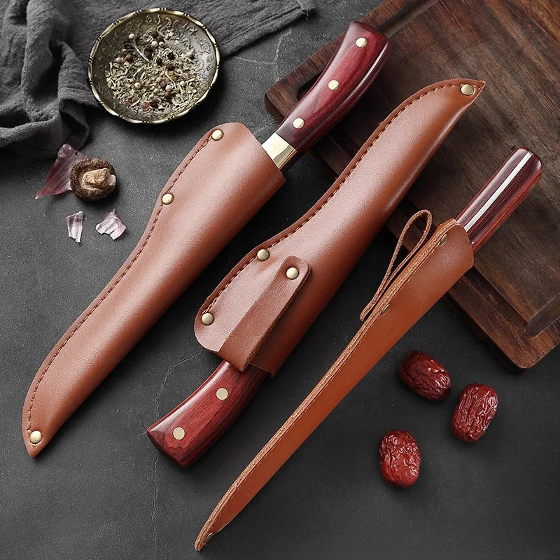 A set of three forged boning knives with wooden handles and stainless steel blades resting on a dark surface.