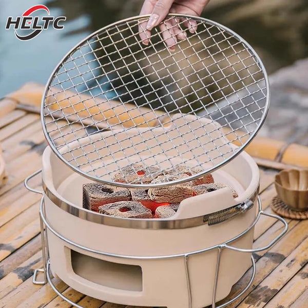 A round stainless steel BBQ grate net is being held over a cooking pot on a wooden surface.