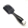 Black paddle hair brush with a handle and a hidden flask for safe liquid storage