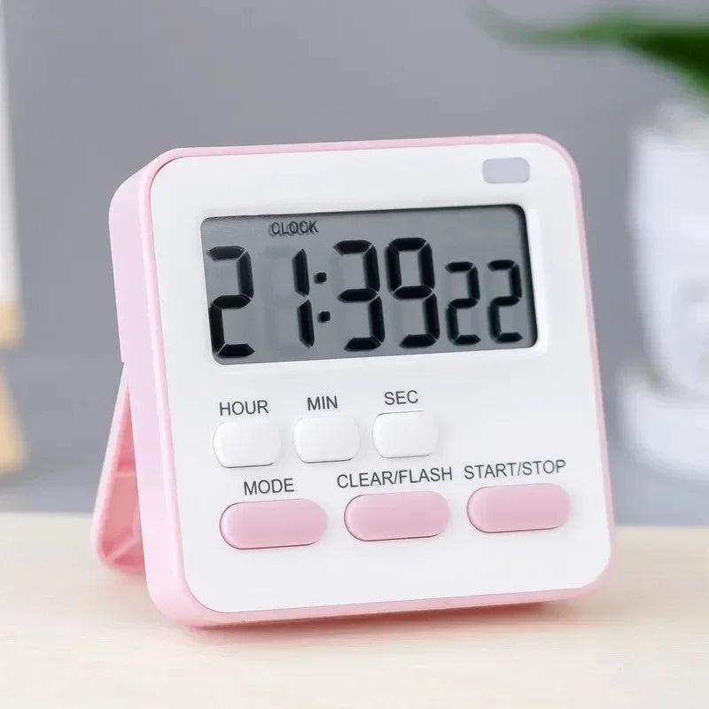 A pink digital kitchen timer displaying 21:39:22 on a white surface.