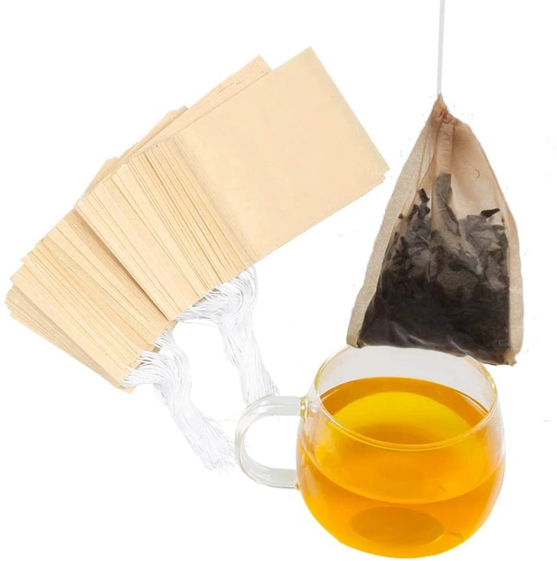 A bundle of biodegradable tea filter bags and a glass of brewed tea.