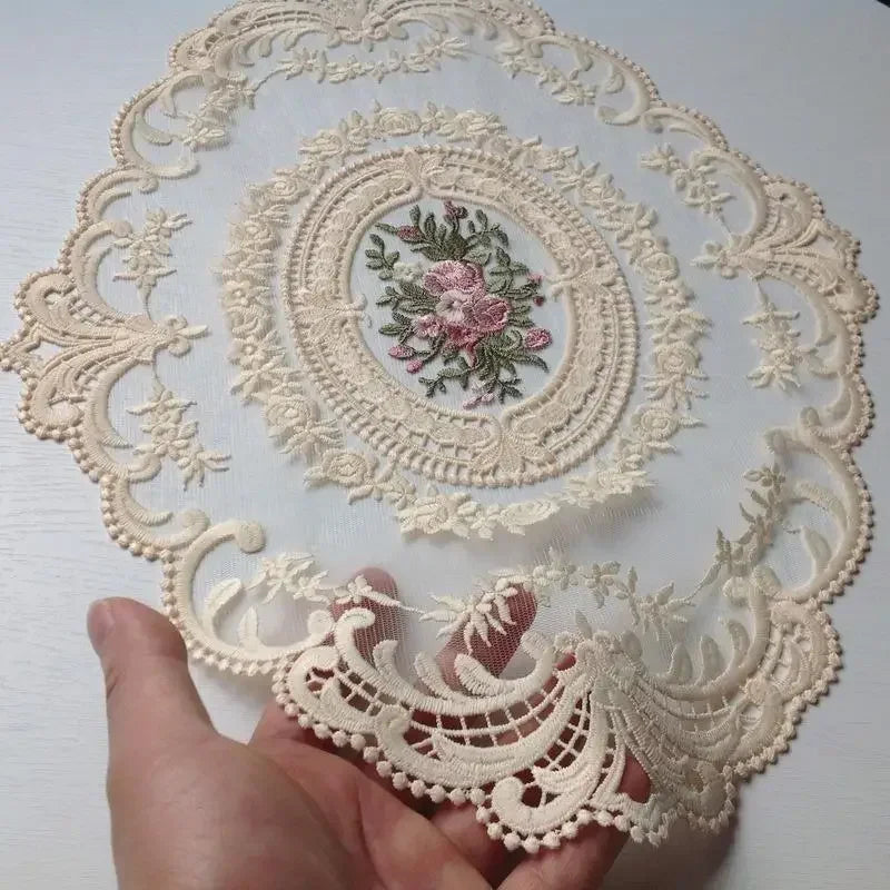 Oval embroidered lace coasters featuring floral patterns and delicate edging for home decor