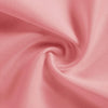 A close-up of a soft pink woven fabric, likely a tablecloth or napkin, shown in a swirling drape.
