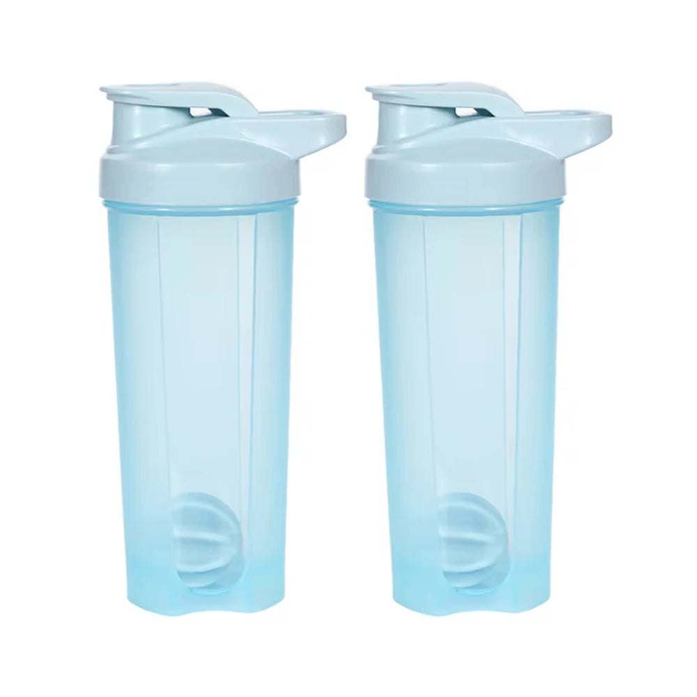 A pair of clear blue protein shaker bottles with blender whisks.