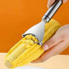 A hand is using a stainless steel corn planer to peel a yellow corn cob.