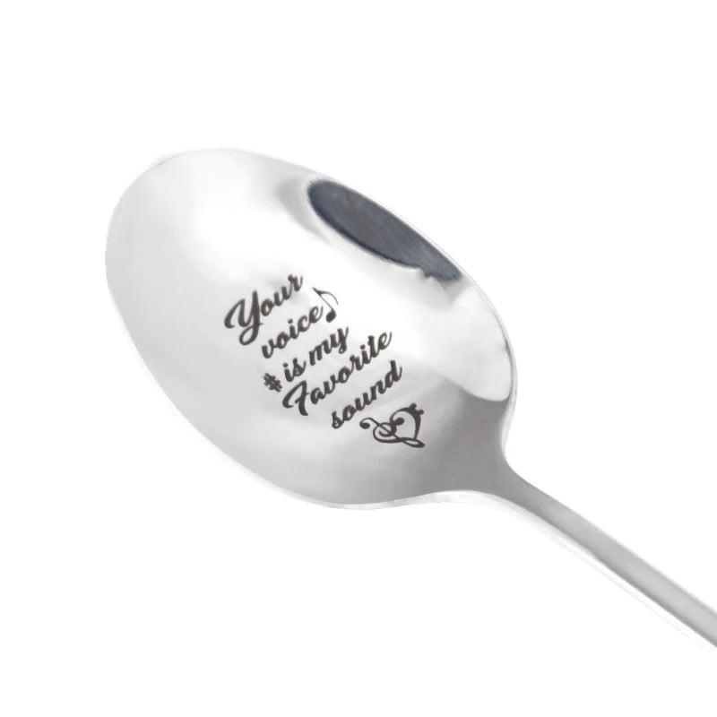 A silver stainless steel milk coffee spoon with the words Your voice is my favorite sound engraved on it.