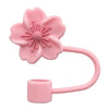 A pink flower straw cap for tumblers with a curved handle.