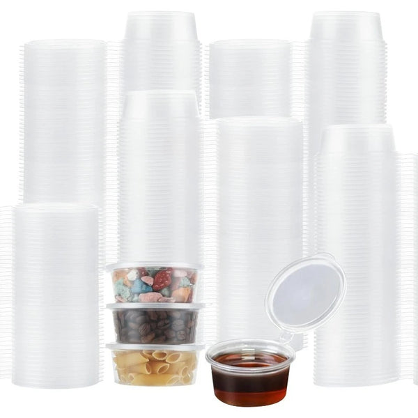 A set of clear, leak-proof disposable sauce cups stacked vertically and displayed next to a small glass container.