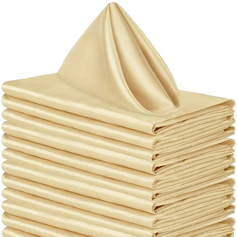 A stack of ten beige satin dinner napkins folded neatly.
