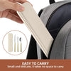 A hand holds a rectangular beige storage case for a portable stainless steel cutlery set, shown next to a gray backpack.