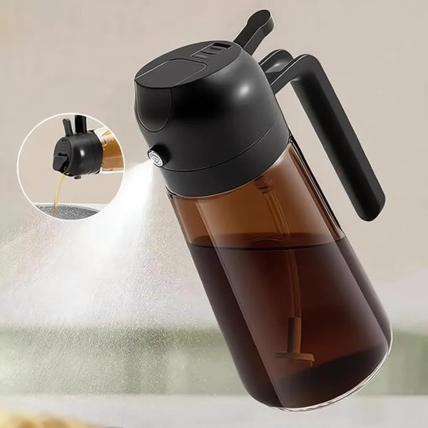 A black glass oil sprayer dispenser bottle is shown spraying a fine mist.