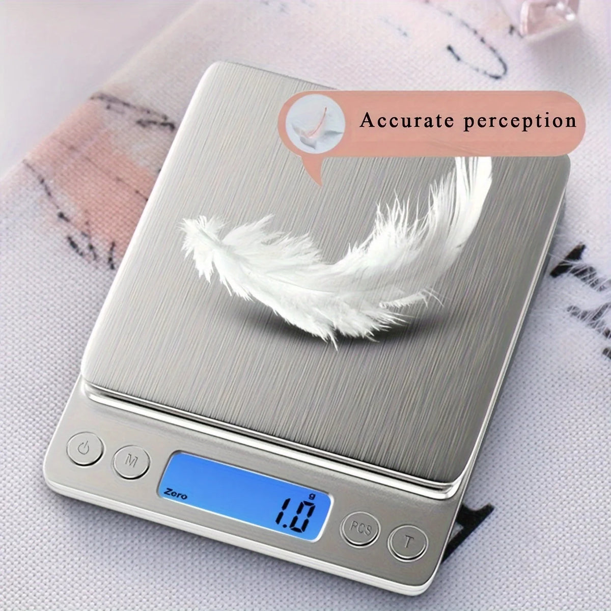 A silver digital kitchen scale with a feather placed on the weighing platform.