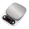 A silver digital kitchen scale with a round weighing platform and display showing zero.