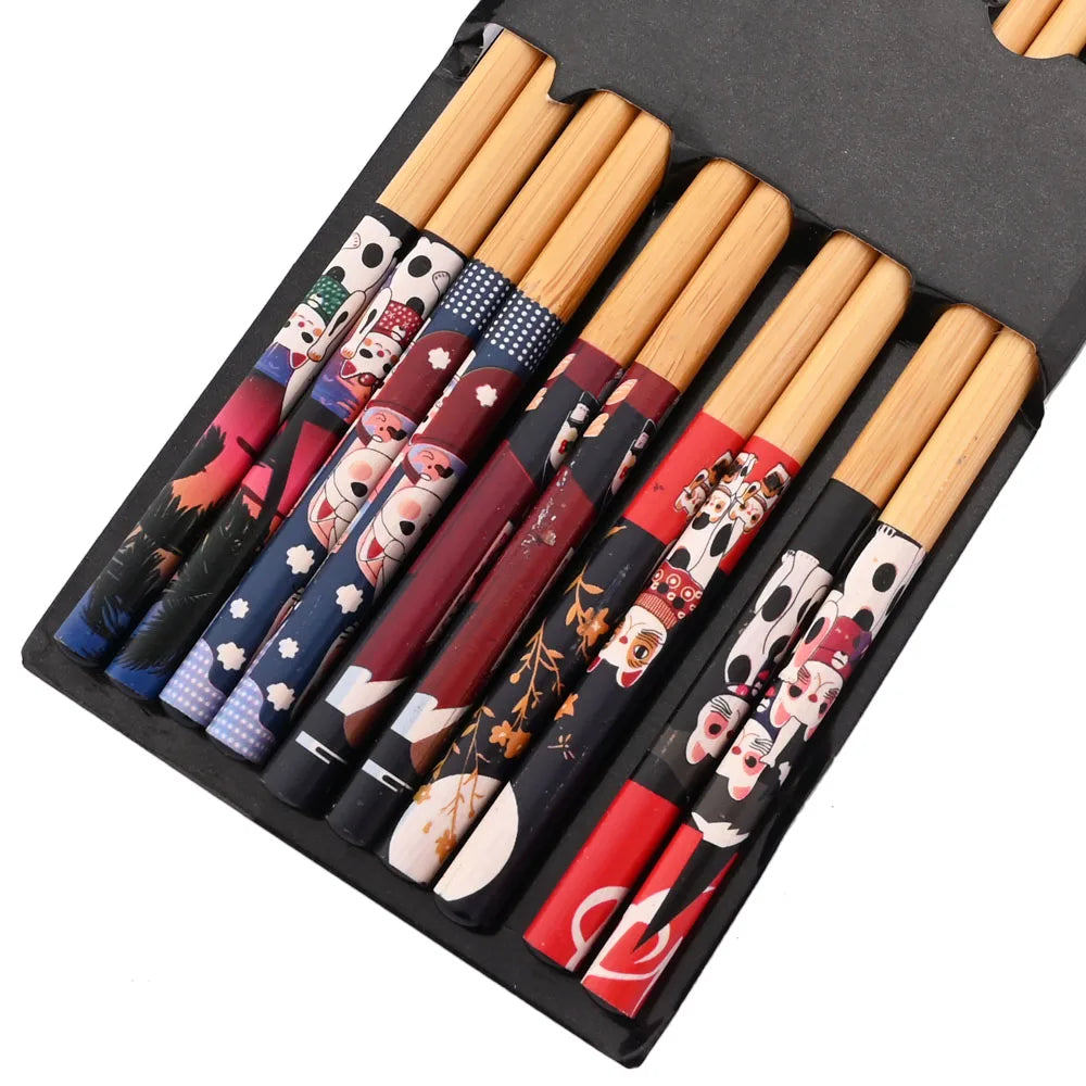 A set of reusable bamboo chopsticks with colorful, patterned tips displayed in a black box.