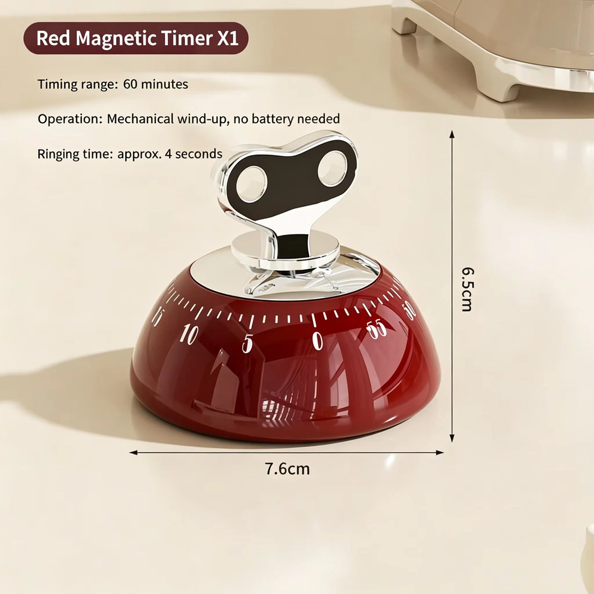 A red magnetic kitchen timer with a silicone base and a silver ringing mechanism is shown on a light surface.