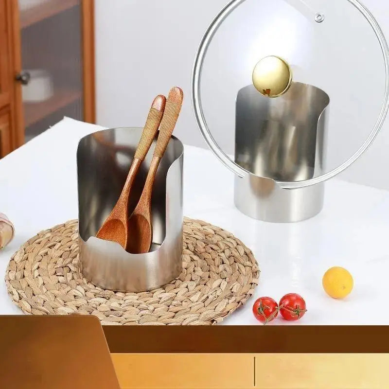 Stainless steel spoon and lid organizer rack with a glass dome on a woven mat