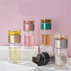A set of double-layer borosilicate glass tea infusers in various colors and natural dried herbs